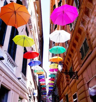 Genova, Italy - 06/01/2020: Bright abstract background of jumble of rainbow colored umbrellas over the city celebrating gay pride