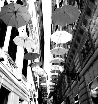 Genova, Italy - 06/01/2020: Bright abstract background of jumble of rainbow colored umbrellas over the city celebrating gay pride