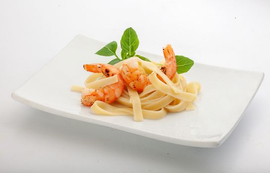 Roasted shrimps with pasta on the plate