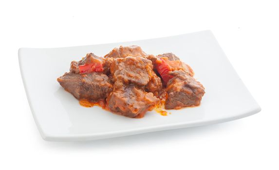 Isolated beef paprikash on the white plate