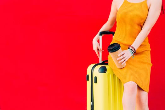 woman sitting on a suitcase and drinking coffee