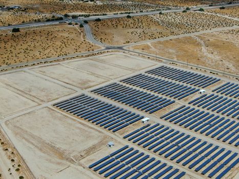 Aerial view of Genuine Energy Farm in the Hot Arid Desert of Palm Springs, California. Solar Panels farm to Harness the Power of Nature to generate free green energy.