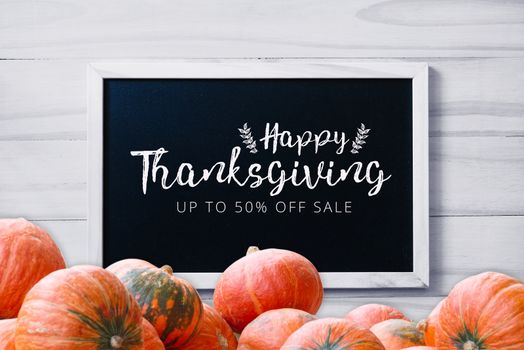 Thanksgiving promotion banner on  blackboard on wood white background with stack of pumpkins greeting season
