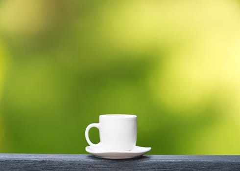 white coffee cup on  green bokeh background with copy space