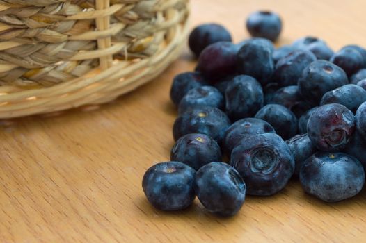 Blueberry with basket on wood table