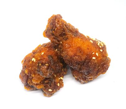 Korean style fried chicken in spicy and sour sauce. Isolated on withe background.