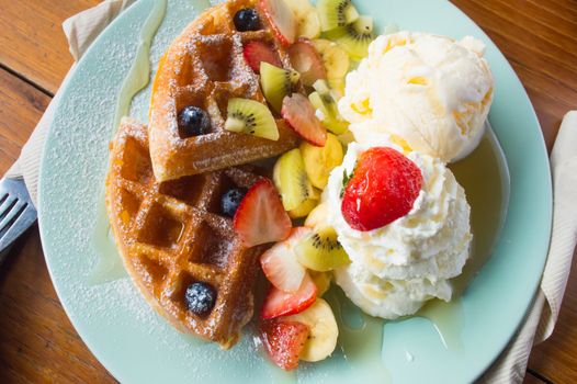  waffles ice cream topping with blueberries and strawberries