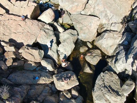 Aerial view of Los Penasquitos Canyon Preserve with the creek waterfall and people enjoying the water. Urban park with trails and river in San Diego, California. USA