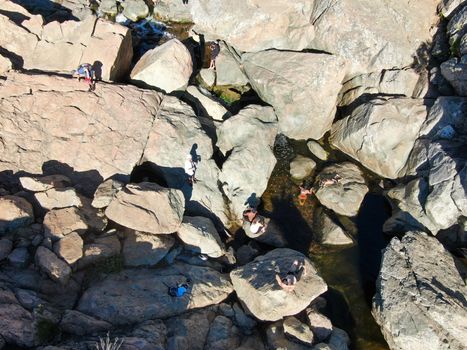 Aerial view of Los Penasquitos Canyon Preserve with the creek waterfall and people enjoying the water. Urban park with trails and river in San Diego, California. USA