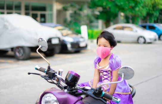 thai girl in princess dress on motorcycle wear a mask against PM 2.5 air pollution