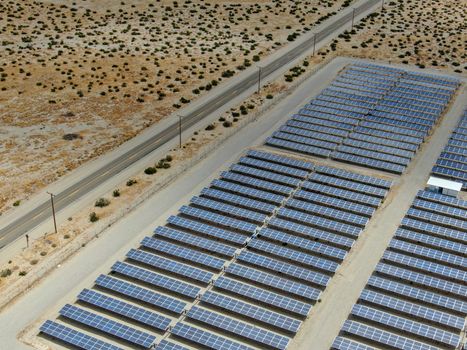 Aerial view of Genuine Energy Farm in the Hot Arid Desert of Palm Springs, California. Solar Panels farm to Harness the Power of Nature to generate free green energy.