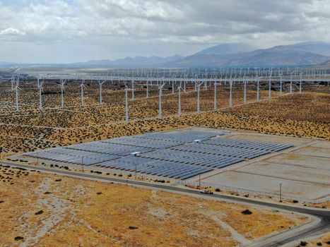 Aerial view of Genuine Energy Farm in the Hot Arid Desert of Palm Springs, California. Solar Panels farm to Harness the Power of Nature to generate free green energy.