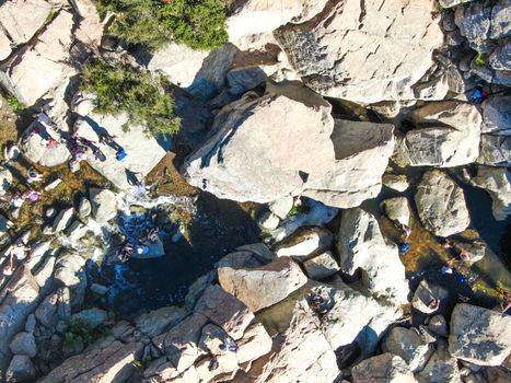 Aerial view of Los Penasquitos Canyon Preserve with the creek waterfall and people enjoying the water. Urban park with trails and river in San Diego, California. USA