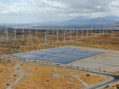 Aerial view of Genuine Energy Farm in the Hot Arid Desert of Palm Springs, California. Solar Panels farm to Harness the Power of Nature to generate free green energy.