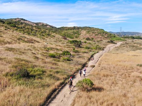 Aerial view of Los Penasquitos Canyon Preserve with tourists, hikers and bikers on the trails,. Urban park with mountain, forest and trails in San Diego, California. USA