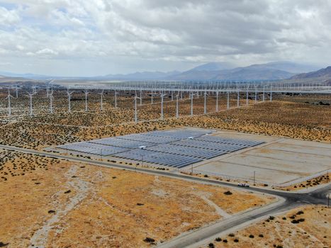 Aerial view of Genuine Energy Farm in the Hot Arid Desert of Palm Springs, California. Solar Panels farm to Harness the Power of Nature to generate free green energy.