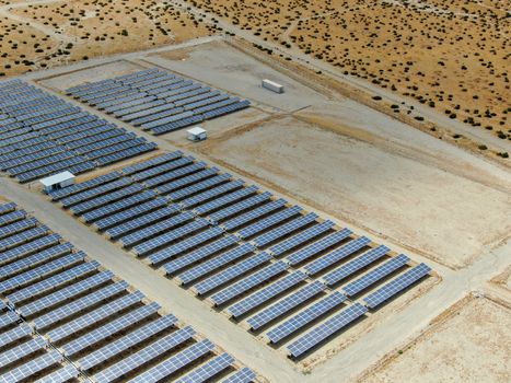 Aerial view of Genuine Energy Farm in the Hot Arid Desert of Palm Springs, California. Solar Panels farm to Harness the Power of Nature to generate free green energy.