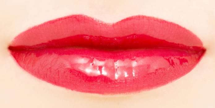 Female lips with glossy lipstick or lip gloss for make-up and beauty ads