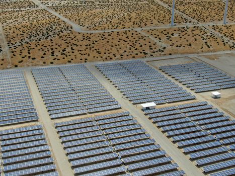 Aerial view of Genuine Energy Farm in the Hot Arid Desert of Palm Springs, California. Solar Panels farm to Harness the Power of Nature to generate free green energy.