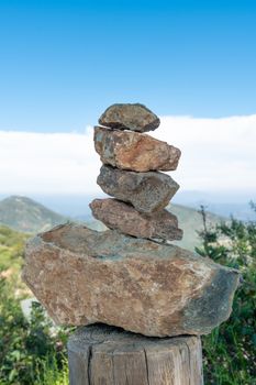 Balancing and concentration zen pile of rocks. Relaxation and meditation through simplicity harmony and rock balance lead to health and wellness. Pile of rocks made on the top of the mountain.