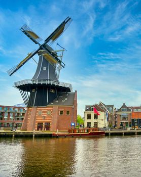 A windmill along the canals in Haarlem, Netherlands on a clear day.