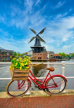 A windmill along the canals in Haarlem, Netherlands on a clear day.