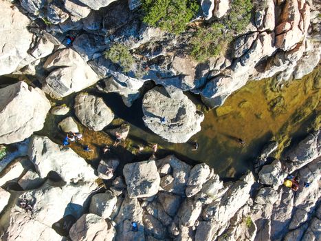 Aerial view of Los Penasquitos Canyon Preserve with the creek waterfall and people enjoying the water. Urban park with trails and river in San Diego, California. USA
