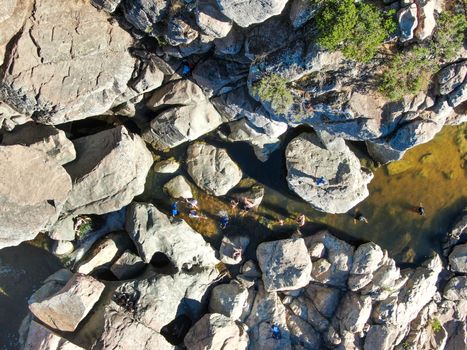 Aerial view of Los Penasquitos Canyon Preserve with the creek waterfall and people enjoying the water. Urban park with trails and river in San Diego, California. USA