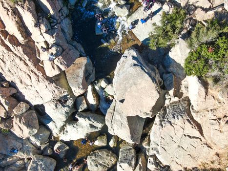 Aerial view of Los Penasquitos Canyon Preserve with the creek waterfall and people enjoying the water. Urban park with trails and river in San Diego, California. USA