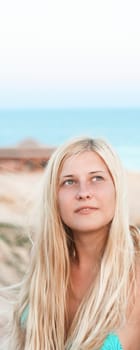 Woman with blond hair enjoying seaside and beach lifestyle in summertime, holiday travel and leisure concept