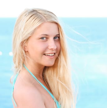 Woman with blond hair enjoying seaside and beach lifestyle in summertime, holiday travel and leisure concept