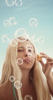 Blonde girl and soap bubbles in summertime, travel and beach lifestyle concept