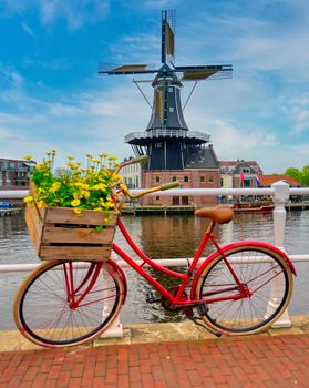 A windmill along the canals in Haarlem, Netherlands on a clear day.