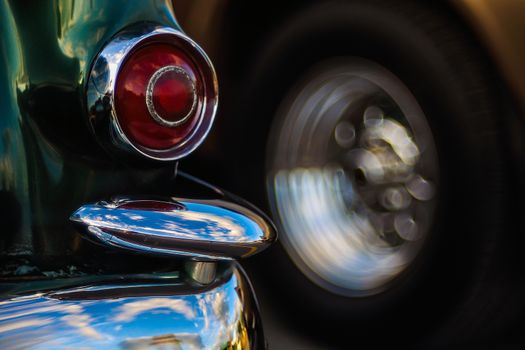 Retro rear headlight lamp vintage classic car. Soft focus, boke background with copy space. Close-up view part of a vintage old car with bubble bokeh effect.