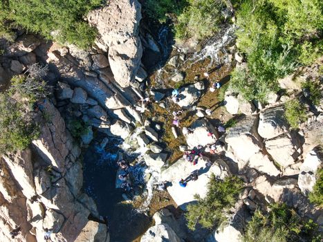 Aerial view of Los Penasquitos Canyon Preserve with the creek waterfall and people enjoying the water. Urban park with trails and river in San Diego, California. USA