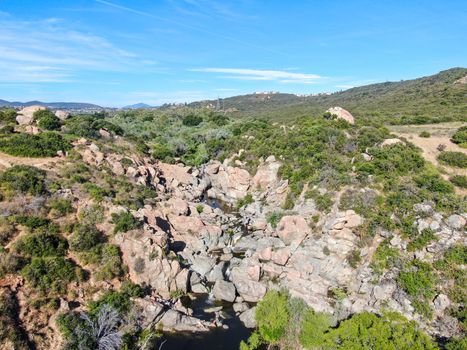 Aerial view of Los Penasquitos Canyon Preserve with the creek waterfall and people enjoying the water. Urban park with trails and river in San Diego, California. USA