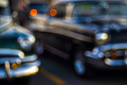Abstract background with bokeh defocused classic car. Colorful abstract background retro car. Boke background with copy space. Close-up view vintage auto details with bubble bokeh effect.