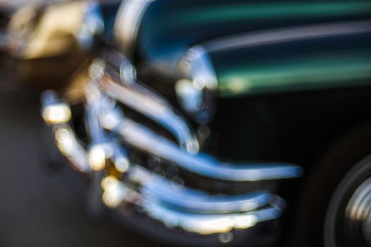 Classic car abstraction background. Soft focus, boke background with copy space. Vintage car details close up view. Abstract blur background of vintage car with bubble bokeh.