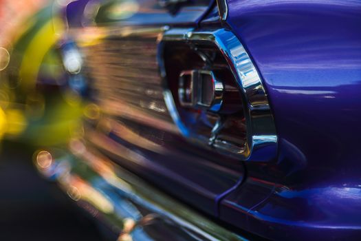 Retro rear headlight lamp vintage classic car. Soft focus, boke background with copy space. Close-up view part of a vintage old car with bubble bokeh effect.