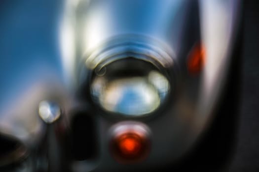 Retro headlight lamp vintage classic car. Soft focus, boke background with copy space. Close-up view part of a vintage old car with bubble bokeh effect.