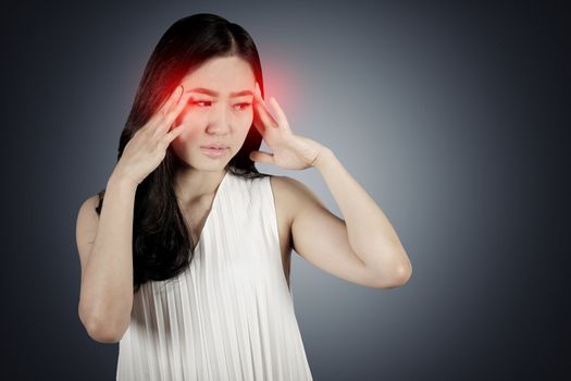 Portrait young woman having headache in dark background with clipping path