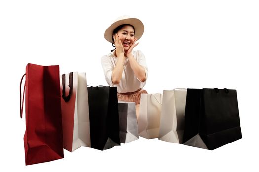 a happy shopaholic women opening a shopping bag on white background with cliping path