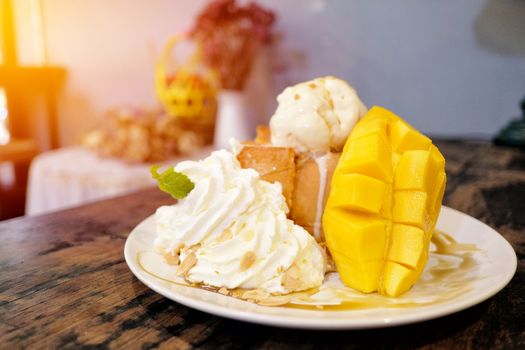 Ice cream with ripe mango and sticky rice in a coconut milk Thai style dessert.