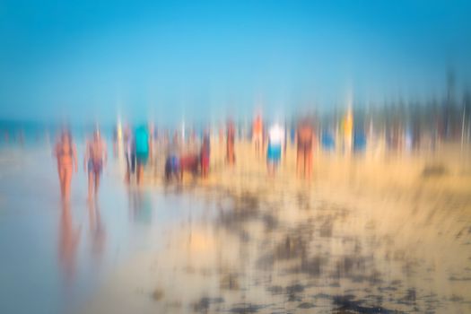 Abstract background image of people walking on the beach in the style of the Impressionists. Soft focus. A blurring technique creates a unique impressionist style. Pastel colours.