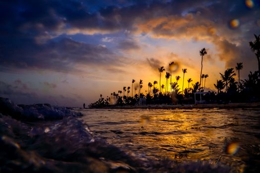 Carribean vacation, beautiful sunset over tropical beach in Punta Cana. Landscape of paradise tropical island beach, sunset shot. Incredible sunset on a tropical island in the ocean.