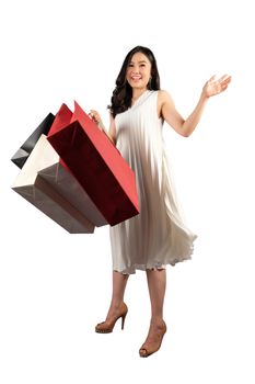 a happy women in white dress with a shopping bag on white background and clipping path