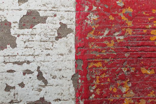 Old red and white paint on a pavement. Grunge texture background.