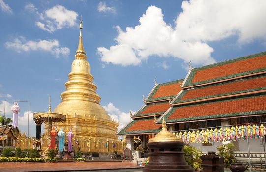 A golden pagoda at Wat Phra That Hariphunchai in Lumphun Province, Thailand after the most recent restoration in October 2019.