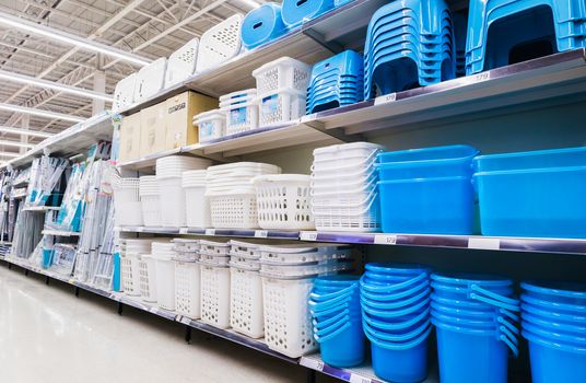 Plastic baskets,Containers and plastic chairs on shelves at grocery store supermarket.Plastic household section in Hypermarket.