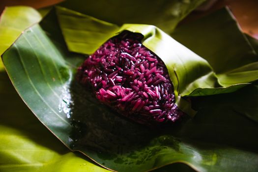 Purple sticky rice on banana leaf package. Organic food background concept.